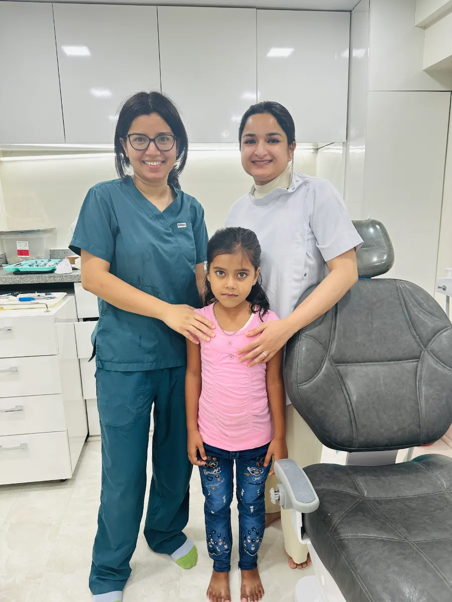 Dentaire Smile Studio dentists with a child patient in the treatment room, Sector 50 Gurgaon