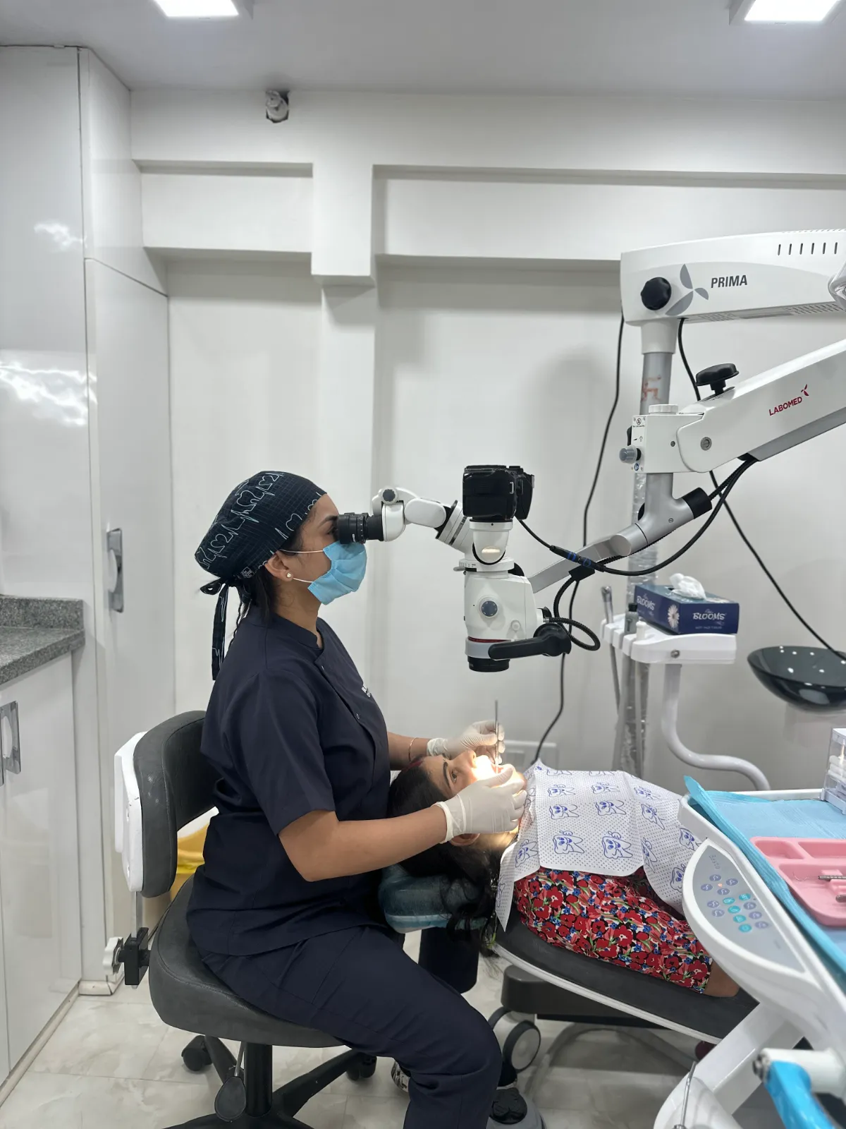 Dr. Aditi Goel using the Labomed dental operating microscope during root canal treatment at Dentaire Smile Studio