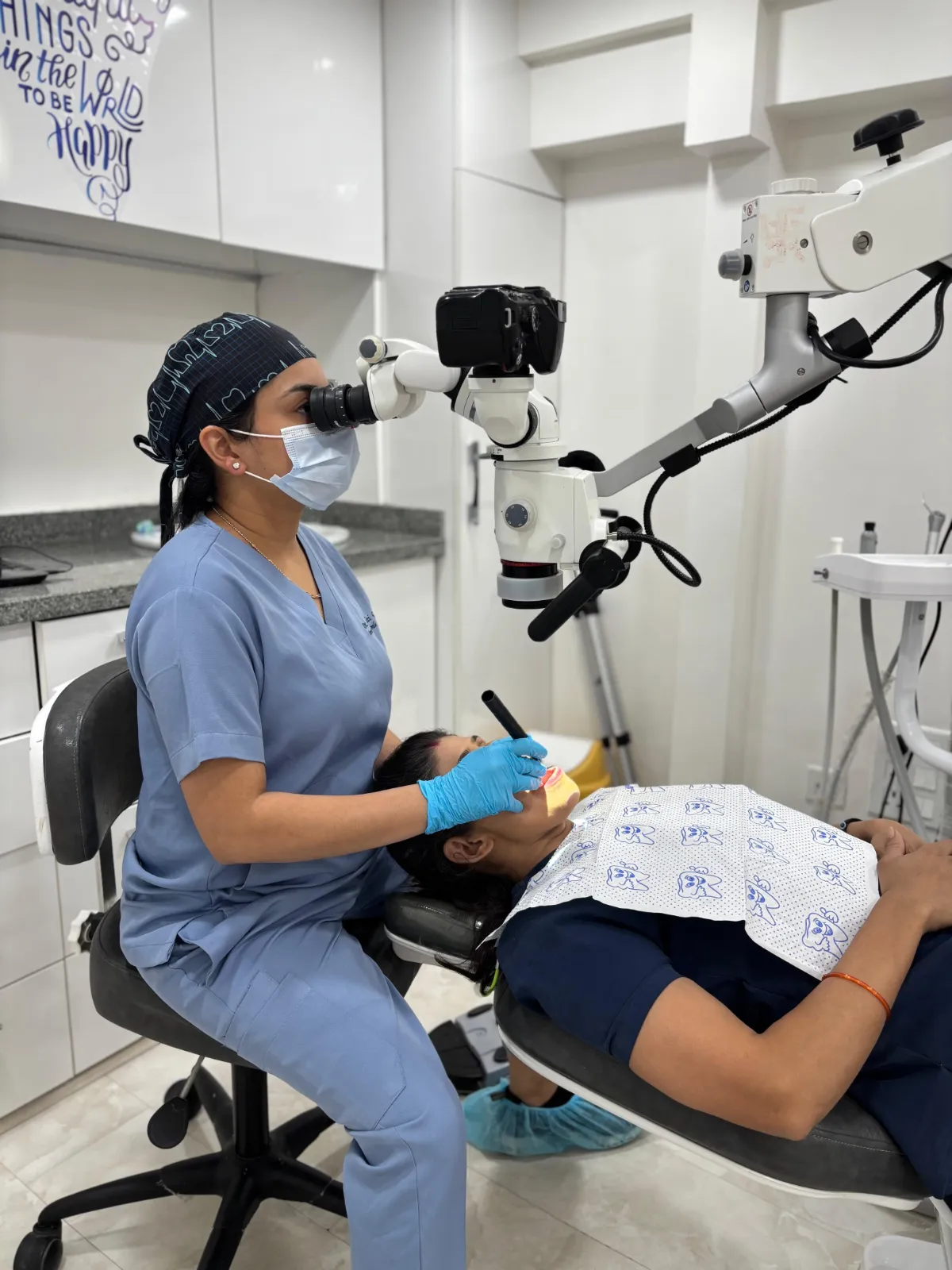 Dr. Aditi Goel performing root canal treatment under a dental operating microscope at Dentaire Smile Studio, Gurgaon