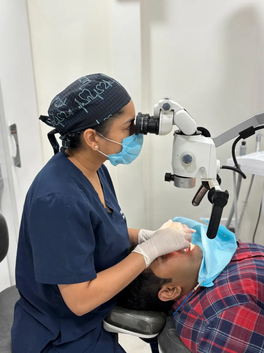 Dr. Aditi Goel performing microscope-assisted dental treatment at Dentaire Smile Studio