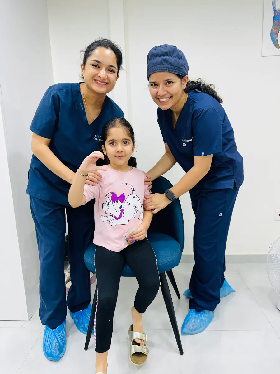 Dentaire Smile Studio dentists with a young patient after her check-up in Sector 50, Gurgaon