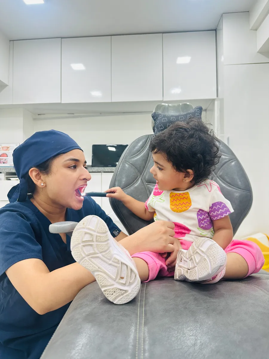 Dr. Aditi Goel making a toddler comfortable in the dental chair at Dentaire Smile Studio, Gurgaon